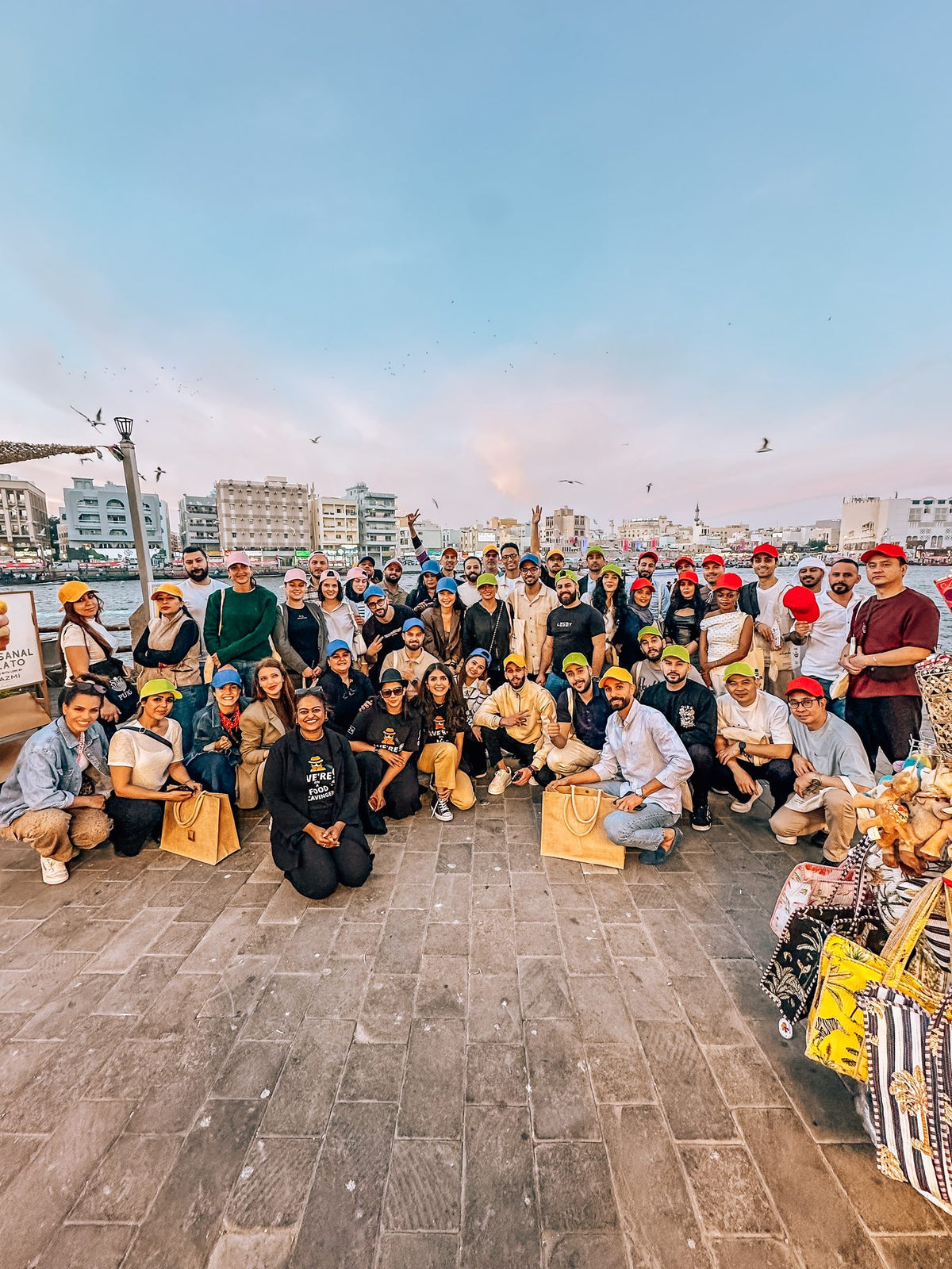 A corporate team gathered on the Dubai Creek waterfront at the end of the Old Dubai Corporate Scavenger Hunt
