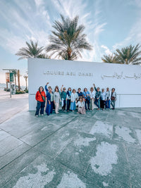 Guests at the Louvre Abu Dhabi sign on the Abu Dhabi Cultural Tour from Dubai