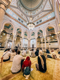 Guests seated on the carpet for a talk inside Jumeirah Mosque on the Dubai Parents' Day Out Tour