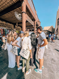 A scavenger hunt team working through a clue in an Old Dubai souk
