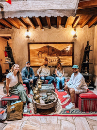 Old Dubai Walking Tour guests in a traditional majlis with dallah coffee pots in Al Fahidi Historical Neighbourhood