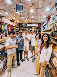 Nada Badran with guests inside a spice and nut shop in the Deira Spice Souk on the Old Dubai Walking Tour