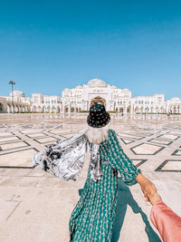 Walking across the forecourt of Qasr Al Watan, the Presidential Palace, on the Abu Dhabi Cultural Tour